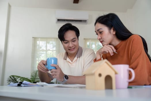 A couple engages in a thoughtful discussion about their financial plans while enjoying coffee and reviewing documents at home.
