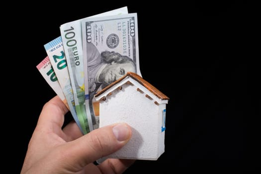 Hand holding American dollar  banknotes isolated on black background
