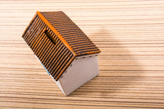 Little model house  and on a parquet background