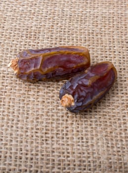 date fruit placed  on a linen canvas background