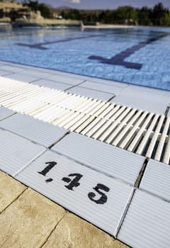 Detail of depth number in an outdoor swimming pool