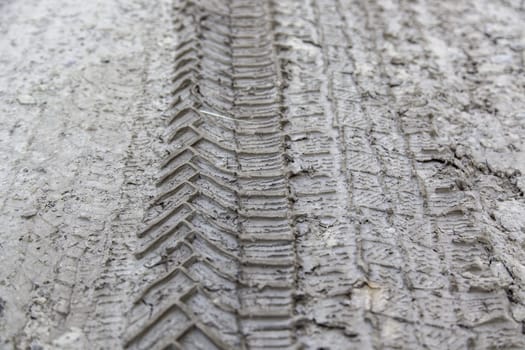 Detail of off-road car marks on a wet and muddy ground