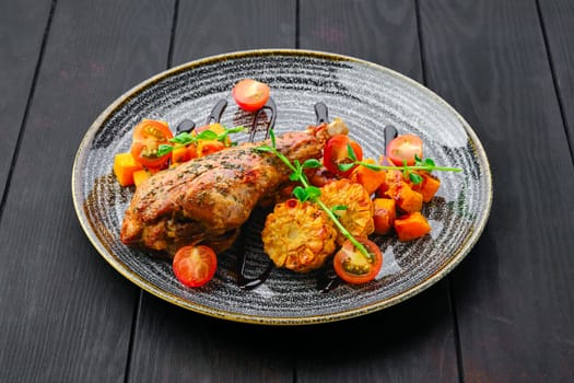 Roaster turkey leg with fried pumpkin and grilled corn decorated with tomato