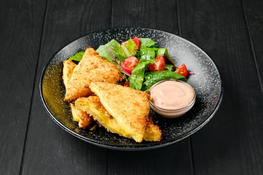 Sandwich with melted cheddar and salad on a plate