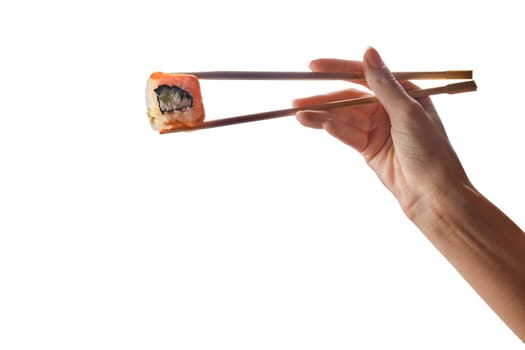 Female hand holding chopsticks with salmon roll isolated on white background