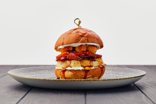 Burger with beef, bacon, pumpkin and tomato