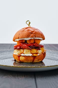Burger with beef, bacon, pumpkin and tomato
