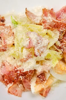 Macro photo of salad with bacon, egg, cabbage and grated cheese