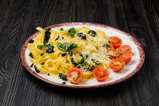Tagliatelle with tomato, parmesan, chopped olives and basil