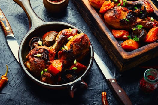 Chicken marinated meat in ginger sauce. Chicken legs fried with pumpkin and mushrooms. Food background