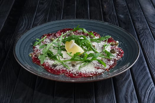 Beef carpaccio with grated cheese, capers, lemon and ruccola