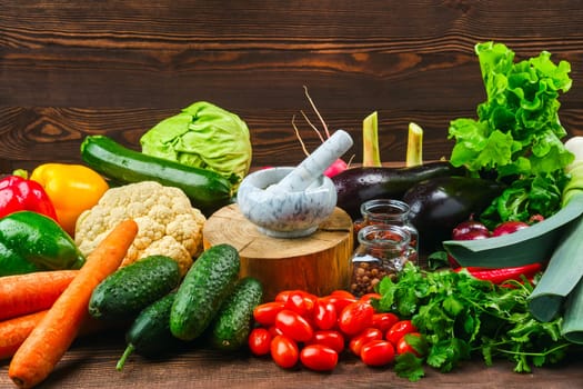 Assortment of fresh vegetables on dark wooden background