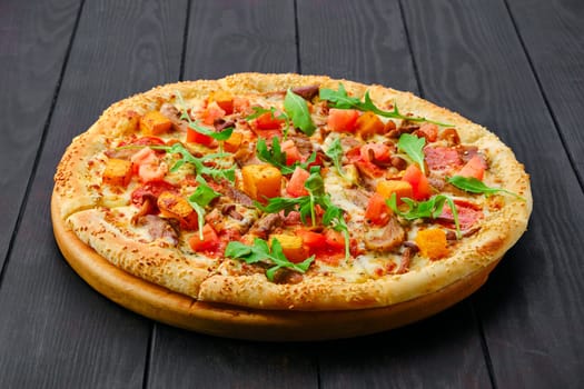 Pizza with pumpkin, sausage, bacon, honey mushrooms and arugula