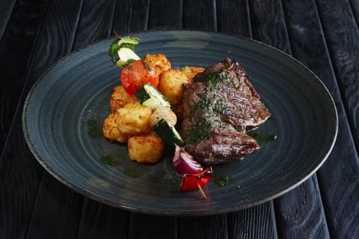 Juicy grilled beef fillet with potato, mushroom, zucchini, tomato, pepper and red onion on wooden skewer