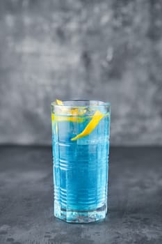 Variation of blue lagoon cocktail  with vodka, blue liquor, ice and lemon