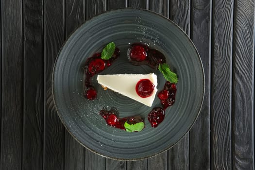 Top view of cheese cake decorated with cherry, strawberry and raspberry