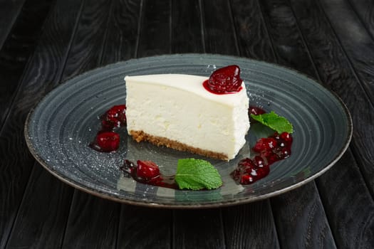Piece of cheese cake decorated with cherry, strawberry and raspberry