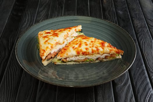 Club sandwich with chicken fillet, pickled cucumber , salad and melted cheese