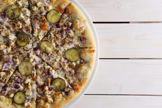 Pizza with onion, mushrooms and pickled cucumber