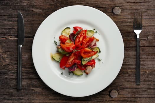 Grilled vegetables on white plate cutted on slices, top view.