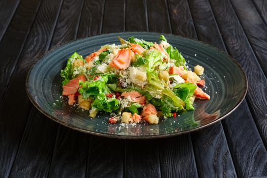Plate with smoked salmon salad with chips, shrimps and cheese