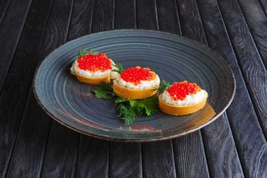 Appetizer for reception. Baguette, bread and butter with ricotta and salmon caviar