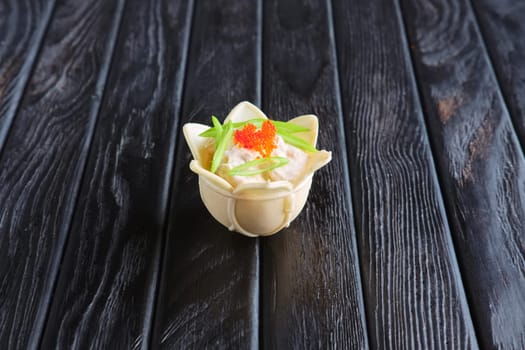 Appetizer for reception.Tartlet with mozzarella and caviar