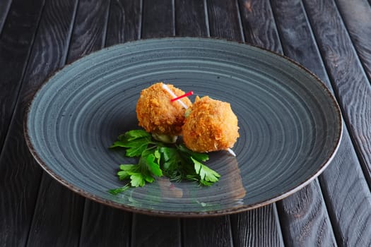 Appetizer for reception. Fried mozzarella balls rolled in bacon in breading