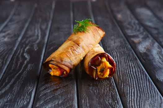 Appetizer for reception. Eggplant stuffed with fried carrot, onion, cheese and egg