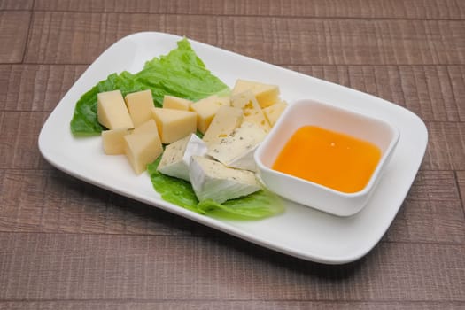 Plate with three kinds of cheese. Cheeseboard.