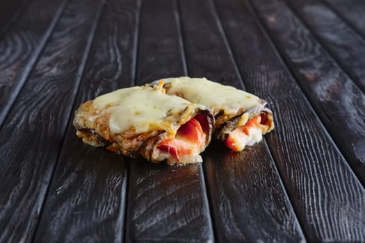 Appetizer for reception. Eggplant stuffed with bacon, ham, onion topped with melted cheese