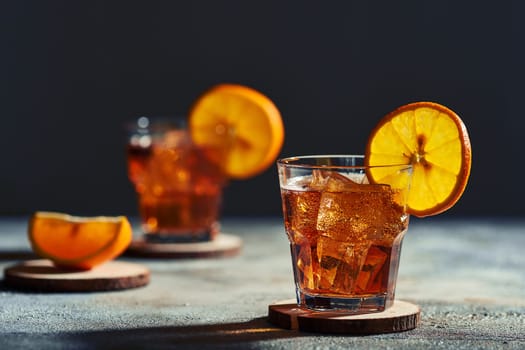 Cocktail old fashioned with hard light and harsh shadows.