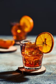 Cocktail old fashioned with hard light and harsh shadows.