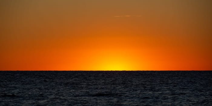 Panorama   -  Light on the horizon over the sea after sunset