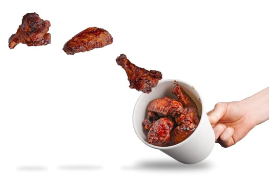 Catching flying fried chicken wings in cardboard container.