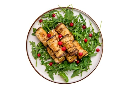 Eggplant rolls stuffed with soft cheese and garlic decorated with arugula and cranberry