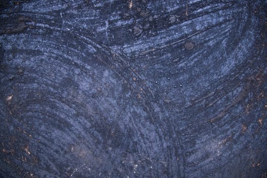 Old metal surface covered black ash  abstract background texture
