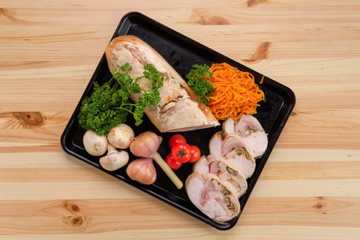 Meatloaf with mushrooms served with spicy carrot, pickled garlic and fresh tomato cherry
