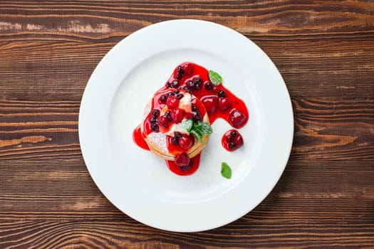Overhead view of american pancakes with strawberry and black currant jam