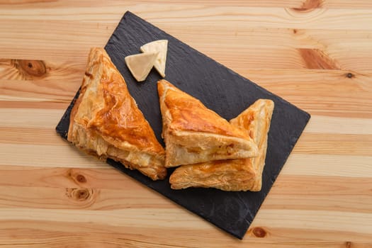 Puff pastry with cheese on slate plate