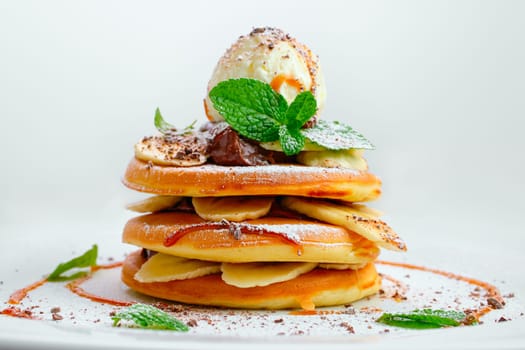 American pancakes with ice cream, banana and nut butter