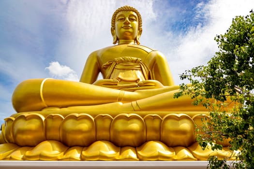 "Phra Buddha Dhammakaya Thep Mongkol"" is a Big golden buddha statue made of copper, as tall as a 20-storey building (69 meters), located at Wat Paknam Bhasicharoen. Bangkok, Thailand on a sunny day"