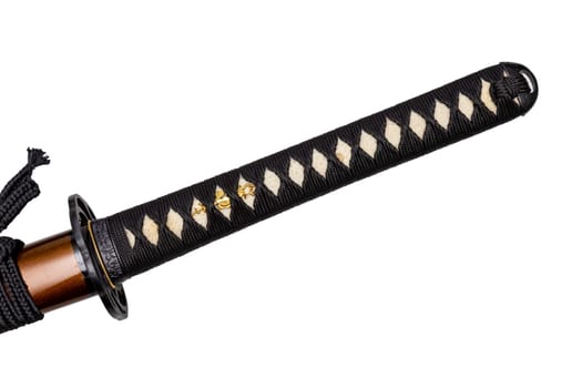 Tsuka - handle of Japanese sword wrapped by black silk cord on white ray skin isolated in white background. Selective focus.
