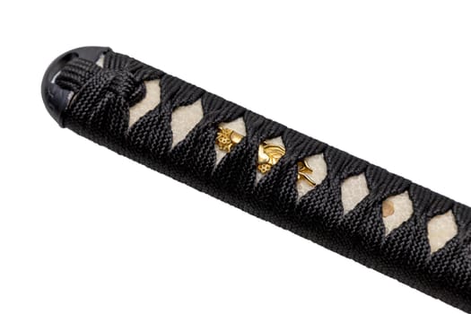 Tsuka - handle of Japanese sword wrapped by black silk cord on white ray skin isolated in white background. Selective focus.