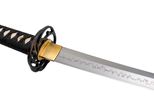 The 'habaki' - collar is made of polished brass. It is at the base of a Japanese sword blade with a wavy pattern on the sharp part. isolated on a white background. Selective focus.