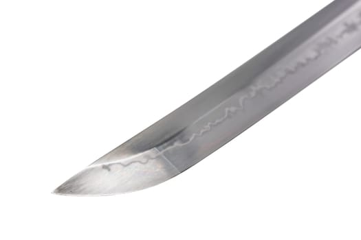 Japanese sword blade on white background. Soft focus. The wavy pattern on the blade edge is a line of hardness that a blacksmith makes so that the blade doesn't break. Choji Hamon style.