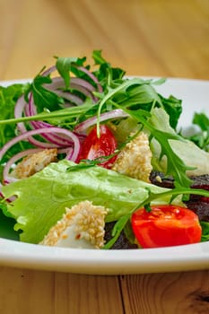 Macro photo of salad with onion, beetroot, tomato, feta and sesame