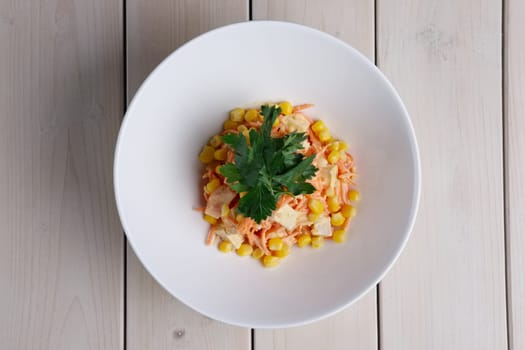 Top view of salad with corn, spicy carrot, chicken and cheese