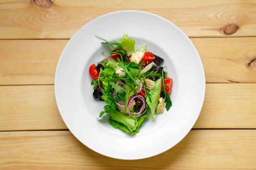Overhead view of salad with onion, beetroot, tomato, feta and sesame