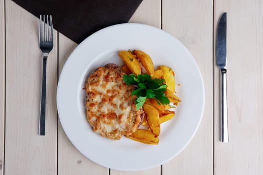 Top view of plate with fried chopped meat and country style potato